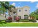 Stunning two-story home with stone accents, lush landscaping, and mature palm trees at 4206 W Sevilla St, Tampa, FL 33629