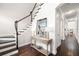 Hallway view of staircase and hardwood floors with a table and mirror at 4206 W Sevilla St, Tampa, FL 33629