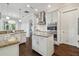 Kitchen featuring stainless steel appliances, white cabinets, dark hardwood floors and granite countertops at 4206 W Sevilla St, Tampa, FL 33629