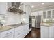 Kitchen showcasing stainless steel appliances, white cabinets, and a herringbone backsplash at 4206 W Sevilla St, Tampa, FL 33629