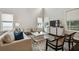 Bright living room featuring high ceilings, multiple windows, and stylish furniture at 4206 W Sevilla St, Tampa, FL 33629