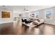 Open loft area with dark hardwood floors, seating area, and abundant natural light at 4206 W Sevilla St, Tampa, FL 33629