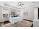 Comfortable main bedroom with tray ceiling, ceiling fan, and large windows at 4206 W Sevilla St, Tampa, FL 33629