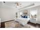Light-filled main bedroom with tray ceiling, ceiling fan, and decorative accents at 4206 W Sevilla St, Tampa, FL 33629