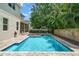 Backyard features a sparkling pool, patio, and lush landscaping with a screened-in lanai at 4206 W Sevilla St, Tampa, FL 33629