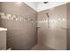 Modern shower with neutral tilework, built-in shelving, and contemporary shower fixtures at 4206 W Sevilla St, Tampa, FL 33629