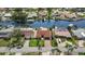 A waterfront home with a red tile roof sits adjacent to waterfront and boat docks amid a residential neighborhood at 4425 13Th Ne Way, St Petersburg, FL 33703