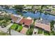 A high angle shot of a quaint waterfront home featuring a red tile roof, boat dock, and mature palms at 4425 13Th Ne Way, St Petersburg, FL 33703