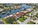 Aerial view of a waterfront home showcasing backyard access to a canal and boat dock at 4425 13Th Ne Way, St Petersburg, FL 33703