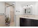 Updated bathroom features tile shower, dark cabinets and decorative mirror at 4425 13Th Ne Way, St Petersburg, FL 33703