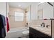 Beautifully updated bathroom with granite vanity, tub with shower, and tile walls at 4425 13Th Ne Way, St Petersburg, FL 33703