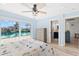 Bedroom with water views, en-suite bath and wood-look tile flooring at 4425 13Th Ne Way, St Petersburg, FL 33703