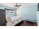 Cozy light blue bedroom with wood floors and lots of natural light at 4425 13Th Ne Way, St Petersburg, FL 33703