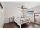 Comfortable bedroom features a decorative ceiling fan, window, and dark hardwood floors at 4425 13Th Ne Way, St Petersburg, FL 33703