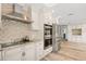 Bright kitchen features stainless appliances, tile backsplash, granite countertops, and custom cabinets at 4425 13Th Ne Way, St Petersburg, FL 33703