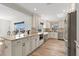 Modern kitchen with white cabinets, granite countertops, stainless steel appliances, and wood floors at 4425 13Th Ne Way, St Petersburg, FL 33703