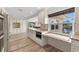 Modern kitchen with white cabinets, granite countertops, stainless steel appliances, and an eat-in counter at 4425 13Th Ne Way, St Petersburg, FL 33703