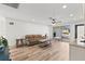 Airy living room featuring wood floors, a comfortable leather couch, and lots of natural light at 4425 13Th Ne Way, St Petersburg, FL 33703