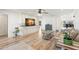 Bright living room with wood floors, a large built-in entertainment center, and neutral walls at 4425 13Th Ne Way, St Petersburg, FL 33703