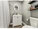 Bathroom with white vanity, oval mirror, and gray walls at 4465 56Th N Ave, St Petersburg, FL 33714