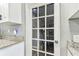Close-up of the kitchen counter, white cabinets, and a door that provides exterior access at 4465 56Th N Ave, St Petersburg, FL 33714