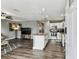 Open concept kitchen and living room with granite countertops, stainless steel appliances, and hardwood flooring at 4465 56Th N Ave, St Petersburg, FL 33714