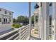 View from balcony of neighboring townhomes, featuring a white railing and exterior lighting at 4757 Legacy Park Dr, Tampa, FL 33611