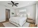 Bright bedroom boasts a ceiling fan, natural light, and wood flooring at 4757 Legacy Park Dr, Tampa, FL 33611