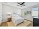 Well-lit bedroom features a ceiling fan and views of the outside at 4757 Legacy Park Dr, Tampa, FL 33611