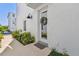 Inviting home entrance with a decorative wreath, modern light fixture, and well-maintained landscaping at 4757 Legacy Park Dr, Tampa, FL 33611