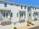 Exterior shot of townhomes featuring white facade, balconies, and garage doors at 4757 Legacy Park Dr, Tampa, FL 33611