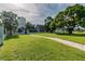 Expansive community grounds featuring lush green grass, mature trees, and walking paths, perfect for outdoor enjoyment at 4757 Legacy Park Dr, Tampa, FL 33611