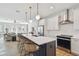 Modern kitchen featuring a large island with bar seating, stainless steel appliances, and white cabinetry at 4757 Legacy Park Dr, Tampa, FL 33611