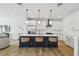 Bright kitchen with a stylish island, modern pendant lighting, stainless appliances, and hardwood floors at 4757 Legacy Park Dr, Tampa, FL 33611