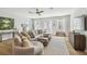 Bright and airy living room with a cozy sectional sofa, large windows, and access to an outdoor space at 4757 Legacy Park Dr, Tampa, FL 33611