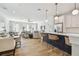 Open-concept living space with kitchen island, dining area, and cozy seating, perfect for modern living at 4757 Legacy Park Dr, Tampa, FL 33611