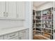 Well-organized walk-in pantry with ample shelving and storage, complemented by white cabinetry and countertops at 4757 Legacy Park Dr, Tampa, FL 33611
