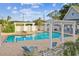 Community pool area with brick pavers, pergola, and clear blue water, perfect for relaxation and enjoying sunny days at 4757 Legacy Park Dr, Tampa, FL 33611