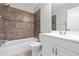 Cozy bathroom featuring a tub with tiled walls and a modern vanity with storage at 5100 Burchette Rd # 3005, Tampa, FL 33647