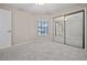Neutral bedroom with plush carpet, closet with mirrored doors, and bright natural light at 5100 Burchette Rd # 3005, Tampa, FL 33647