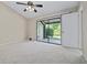 Bright bedroom featuring carpet and sliding glass doors that lead to a screened patio at 5100 Burchette Rd # 3005, Tampa, FL 33647
