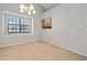 Bright dining area with a window and passthrough to the kitchen, featuring neutral tile floors at 5100 Burchette Rd # 3005, Tampa, FL 33647