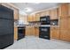 Functional kitchen with black appliances, light cabinets, and tile backsplash at 5100 Burchette Rd # 3005, Tampa, FL 33647