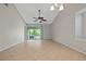 Bright, spacious living room with neutral tile floors and sliding glass doors to the patio at 5100 Burchette Rd # 3005, Tampa, FL 33647