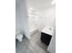 This bathroom has hard surface floors, toilet, vanity and shower with tub at 5310 Companion Ln, Tampa, FL 33619