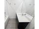 Bathroom includes a dark vanity, white sink and hard surface flooring at 5310 Companion Ln, Tampa, FL 33619