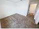 This bedroom is empty with plush carpeting and a door that leads to another room at 5310 Companion Ln, Tampa, FL 33619