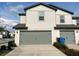 Charming townhome with a gray garage door and concrete driveway at 5310 Companion Ln, Tampa, FL 33619