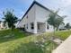 Exterior corner elevation of home showing covered patio area and lush landscaping at 5310 Companion Ln, Tampa, FL 33619