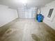 Clean two-car garage with white walls and concrete floor, ready for parking or storage at 5310 Companion Ln, Tampa, FL 33619